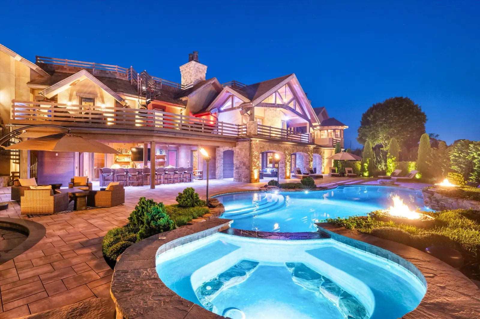 The pool terrace at the Bridgehampton Horse Country Estate at dusk