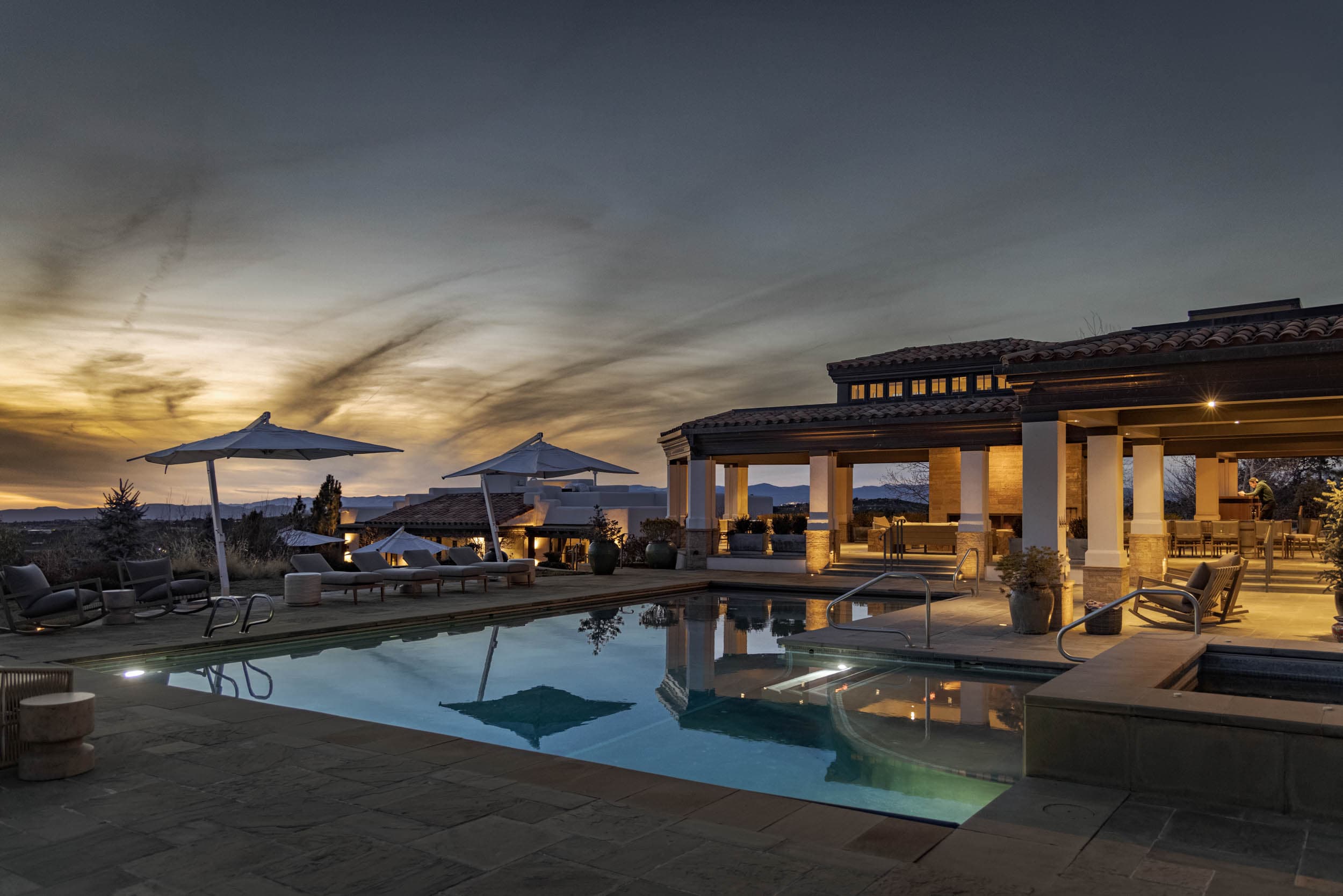 Lit pool and covered loggia at dusk, Vida Encantada, Santa Fe