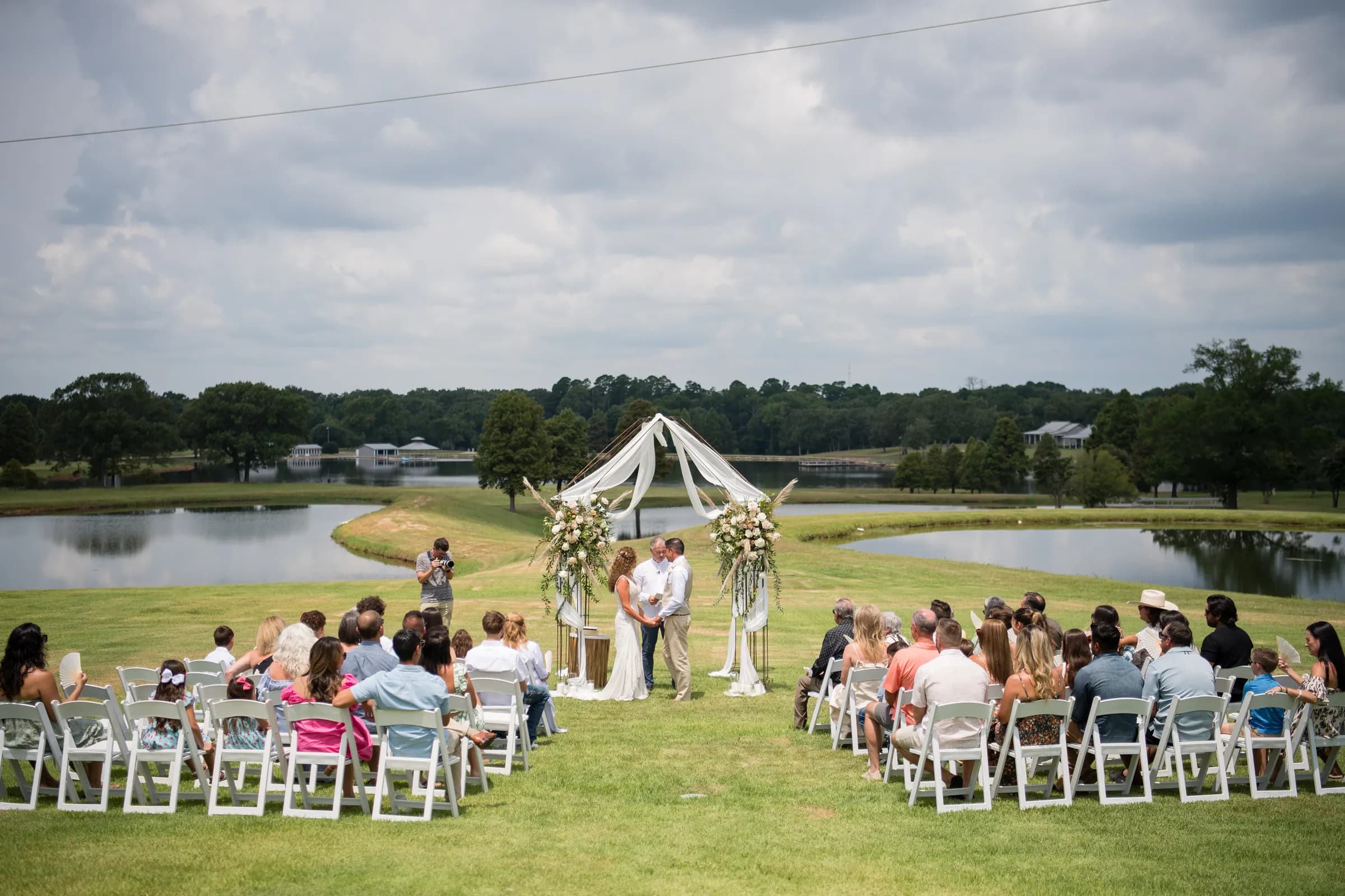 Guests seated for a lakeside ceremony