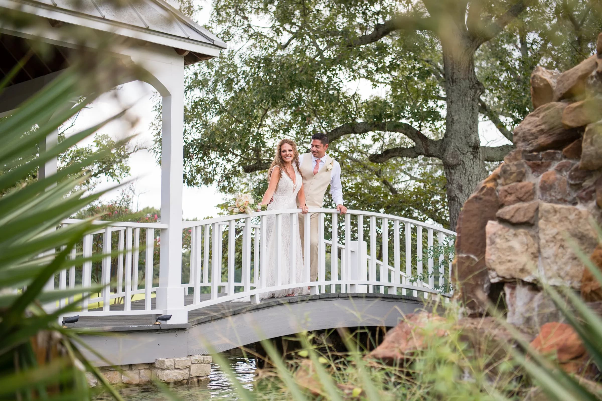 A couple on the white footbridge by the gazebo
